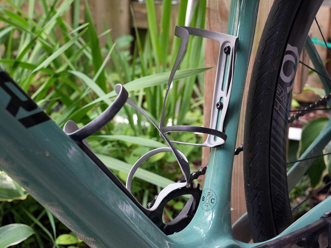 blackburn carbon fiber water bottle cages with huge adjustment range shown mounted on a bike