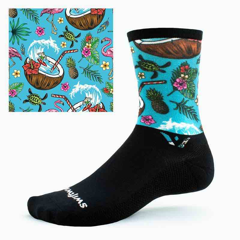 a black swiftwick cycling sock with a teal beach inspired print on the cuff.