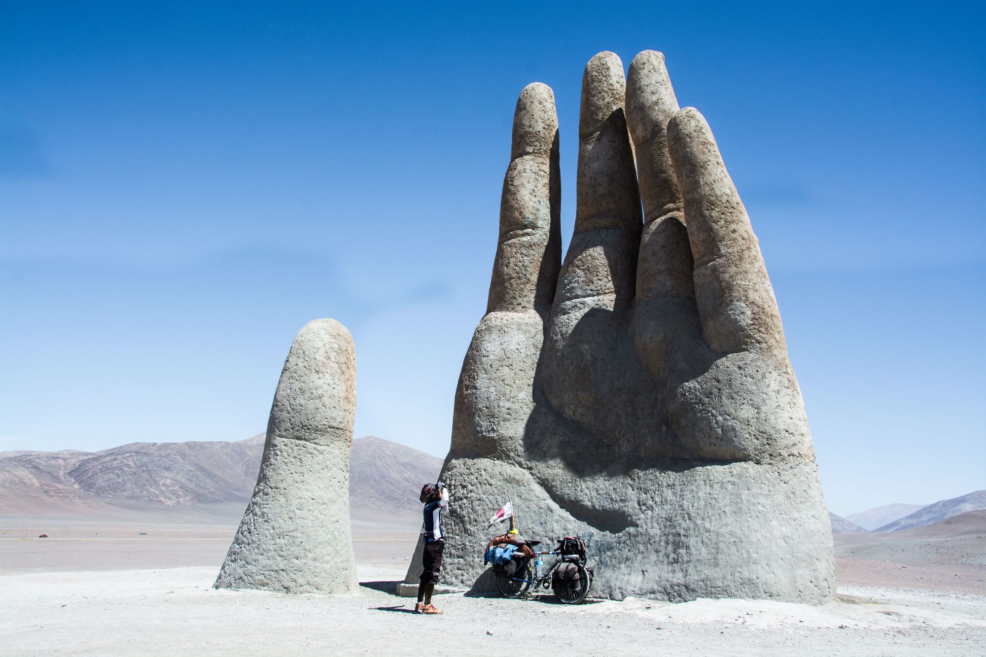 50 ways to cycle the world bike touring sculpture hand
