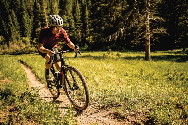 sram xplr gravel bike group overview with cyclist riding through the forest