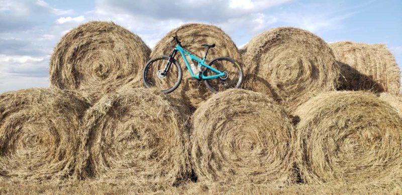 bikerumor pic of the day a bicycle sits atop a stack of round hay bales on a partially sunny day.