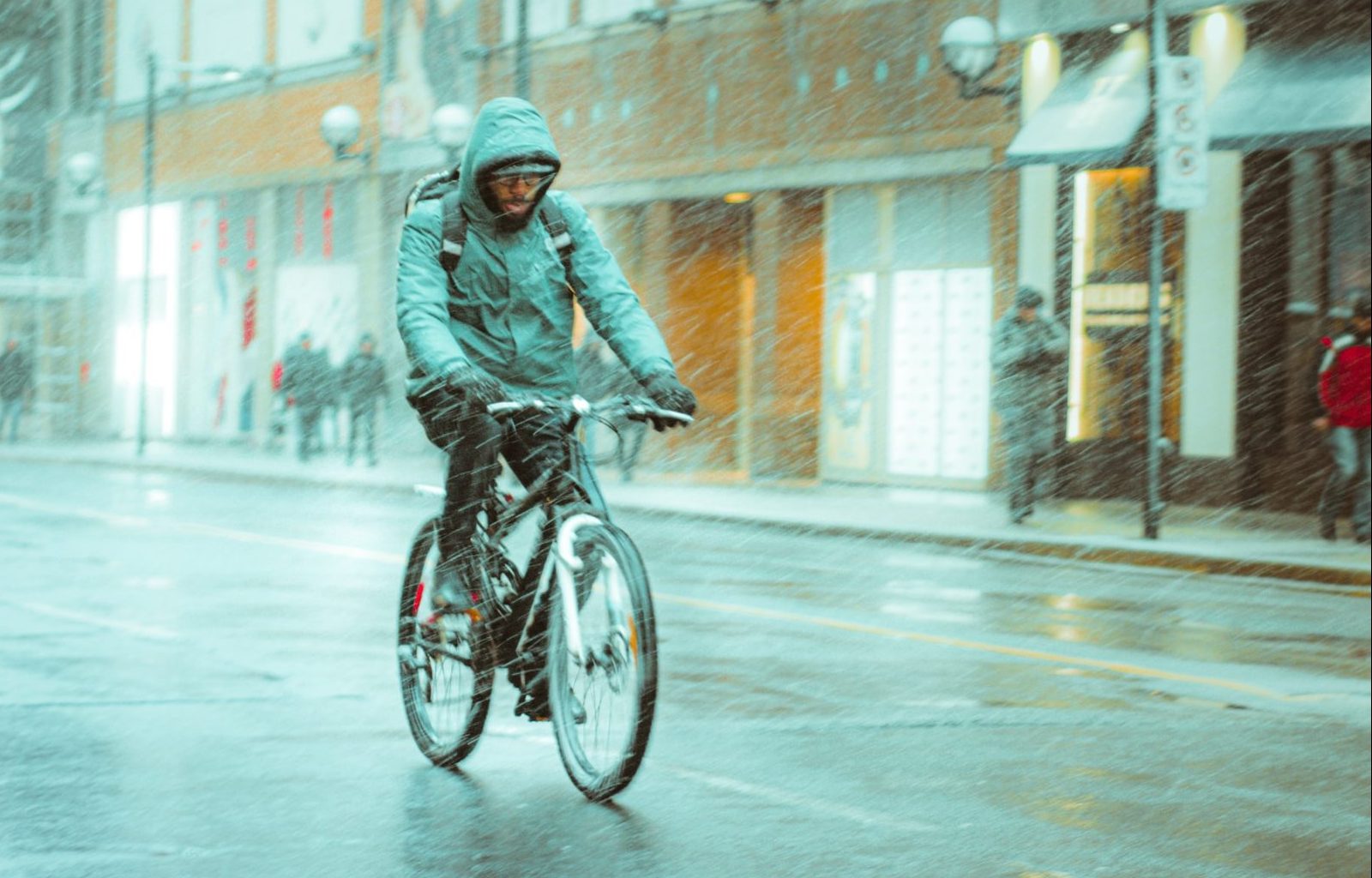 Cycling in the rain; photo by Juan Rojas on Unsplash