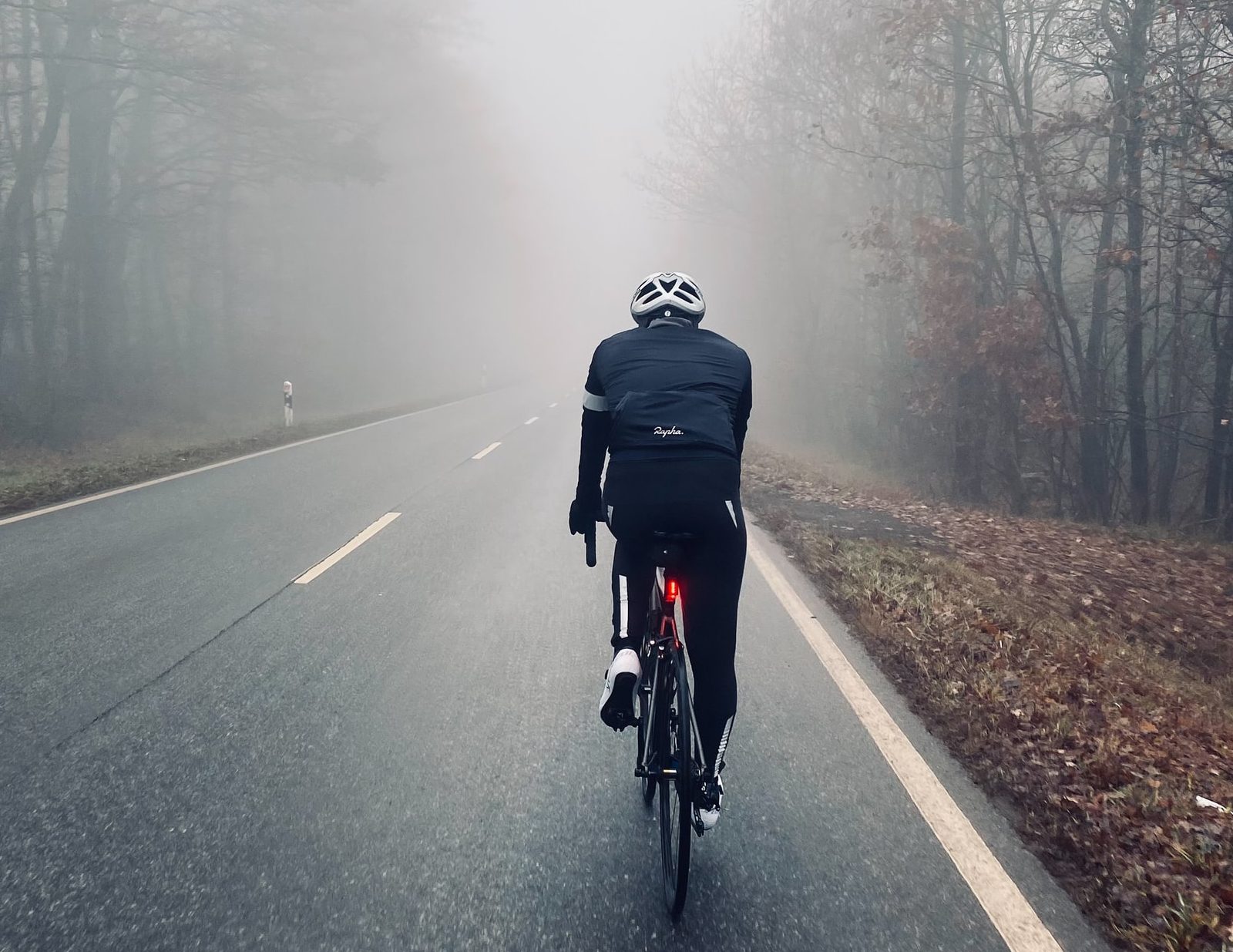 Cycling down a road; photo by Luca Jonas on Unsplash
