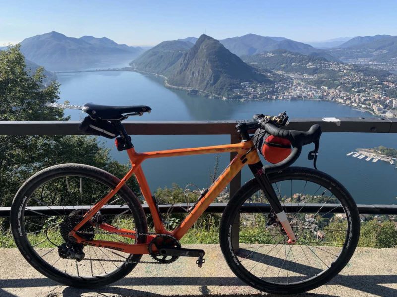 bikerumor pic of the day an on one space chicken gravel bicycle leans against a metal barrier overlooking lake lugano in switzerland.