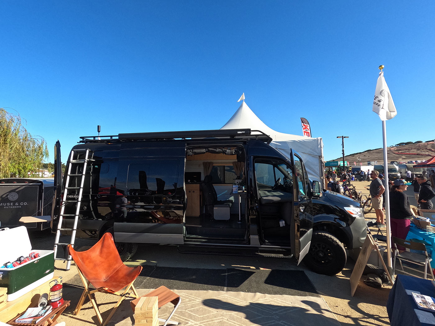 muse outdoors custom sprinter camper van with outdoor shower hose and premium kitchen