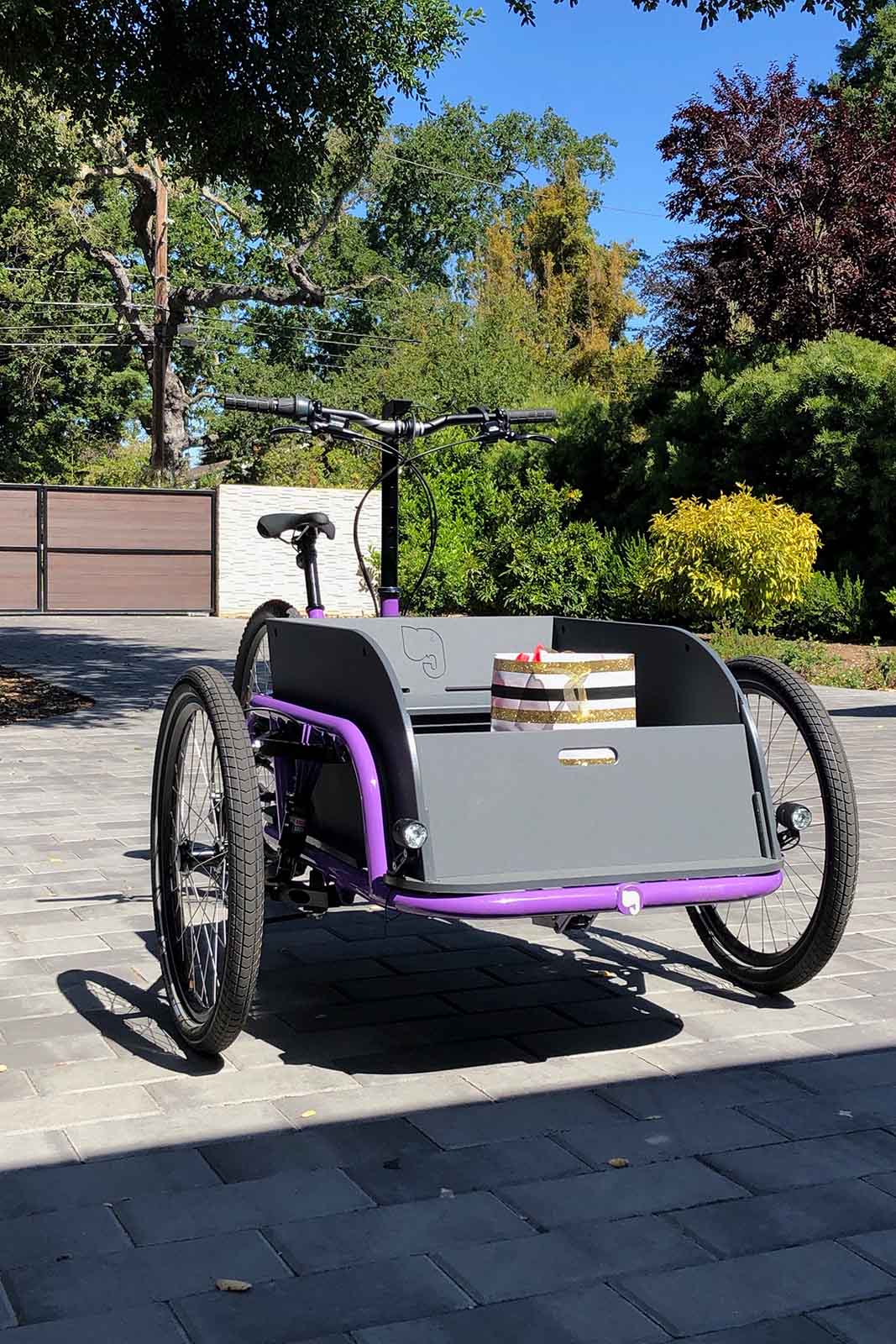 A purple olivetti cargo bike