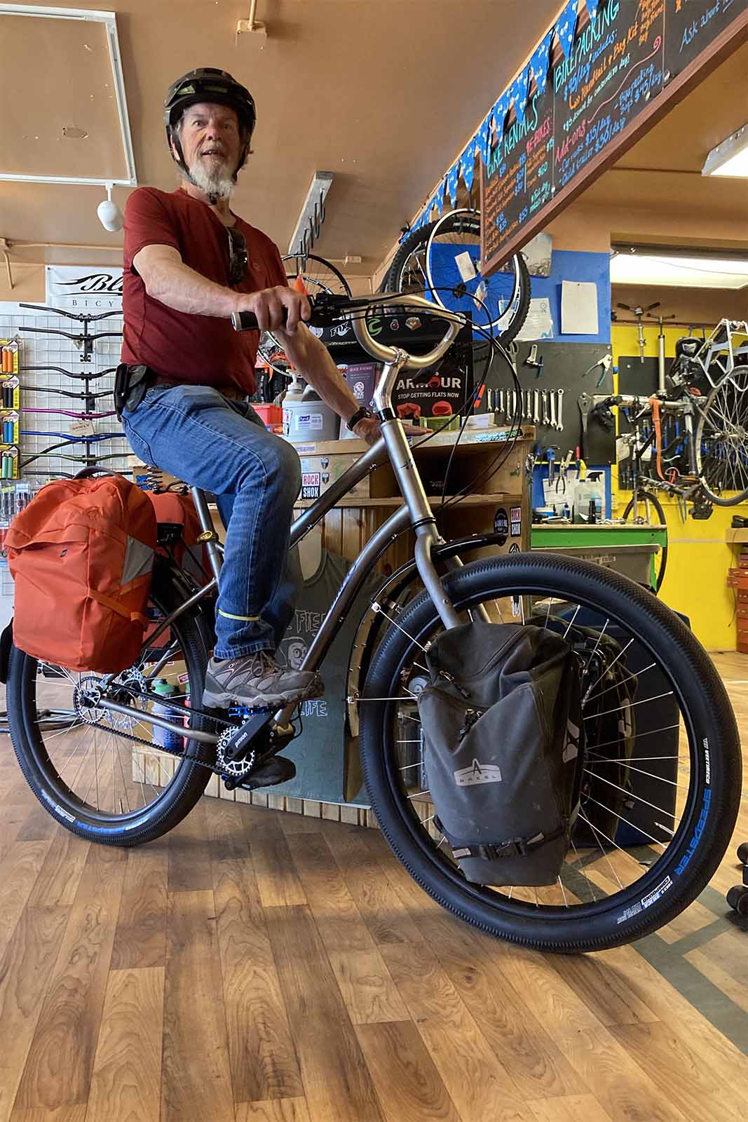a man sits on a pierre chastain bike inside a store