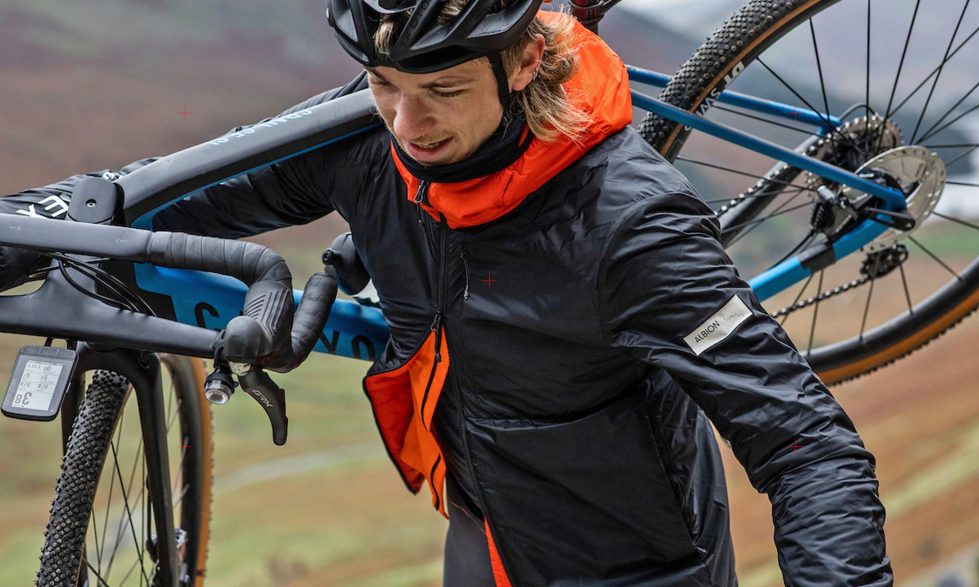 Albion Zoa Insulated Jacket, recycled Pertex fabrics, black & orange on-bike