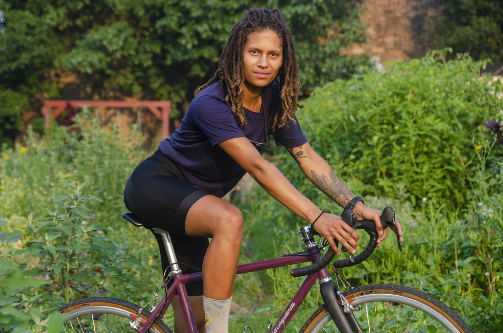 a Black woman rides a pachyderm bike