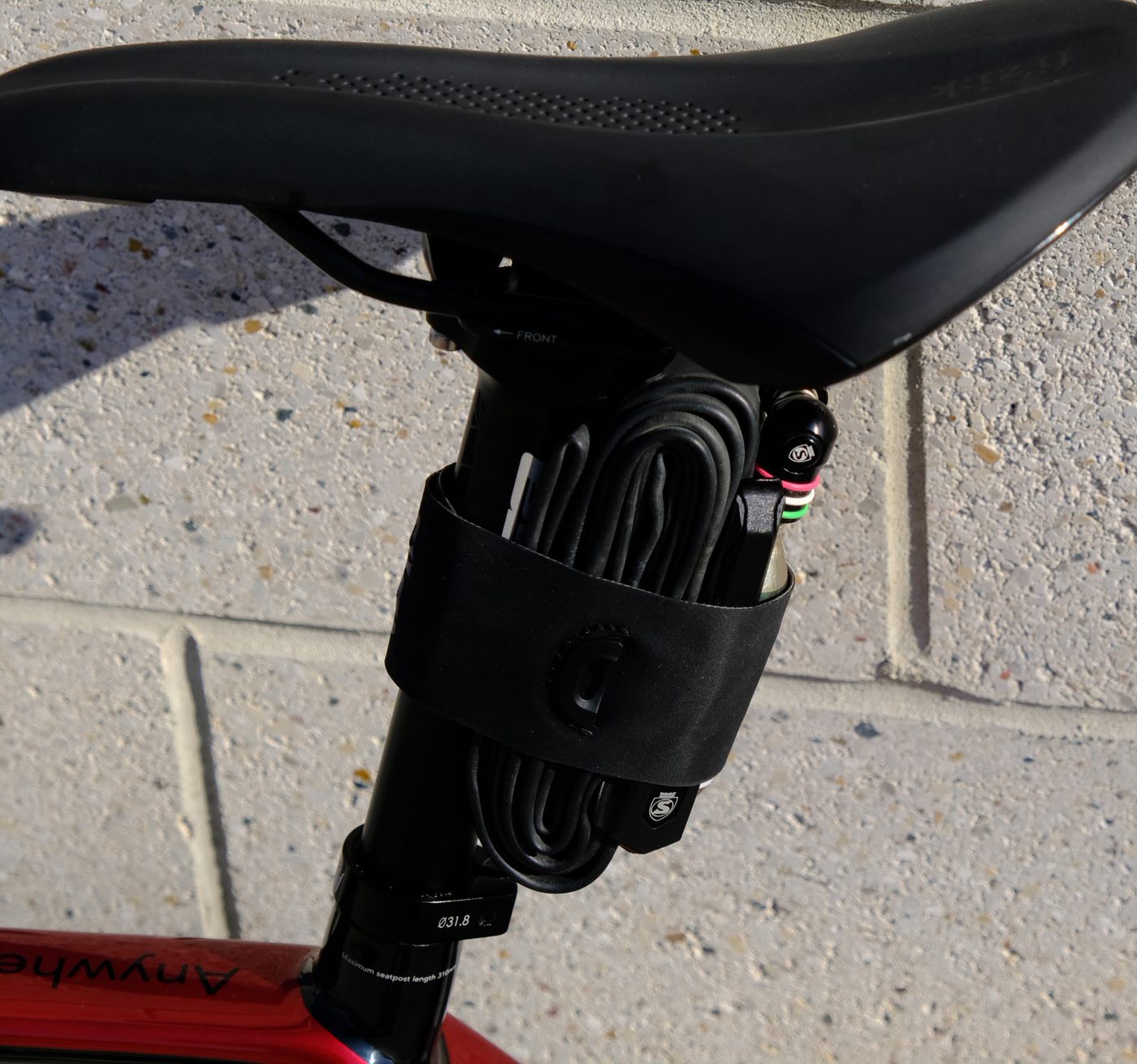 Silca Hypalon EDC Strap holding a spare tube and CO2 canister on a seat post.