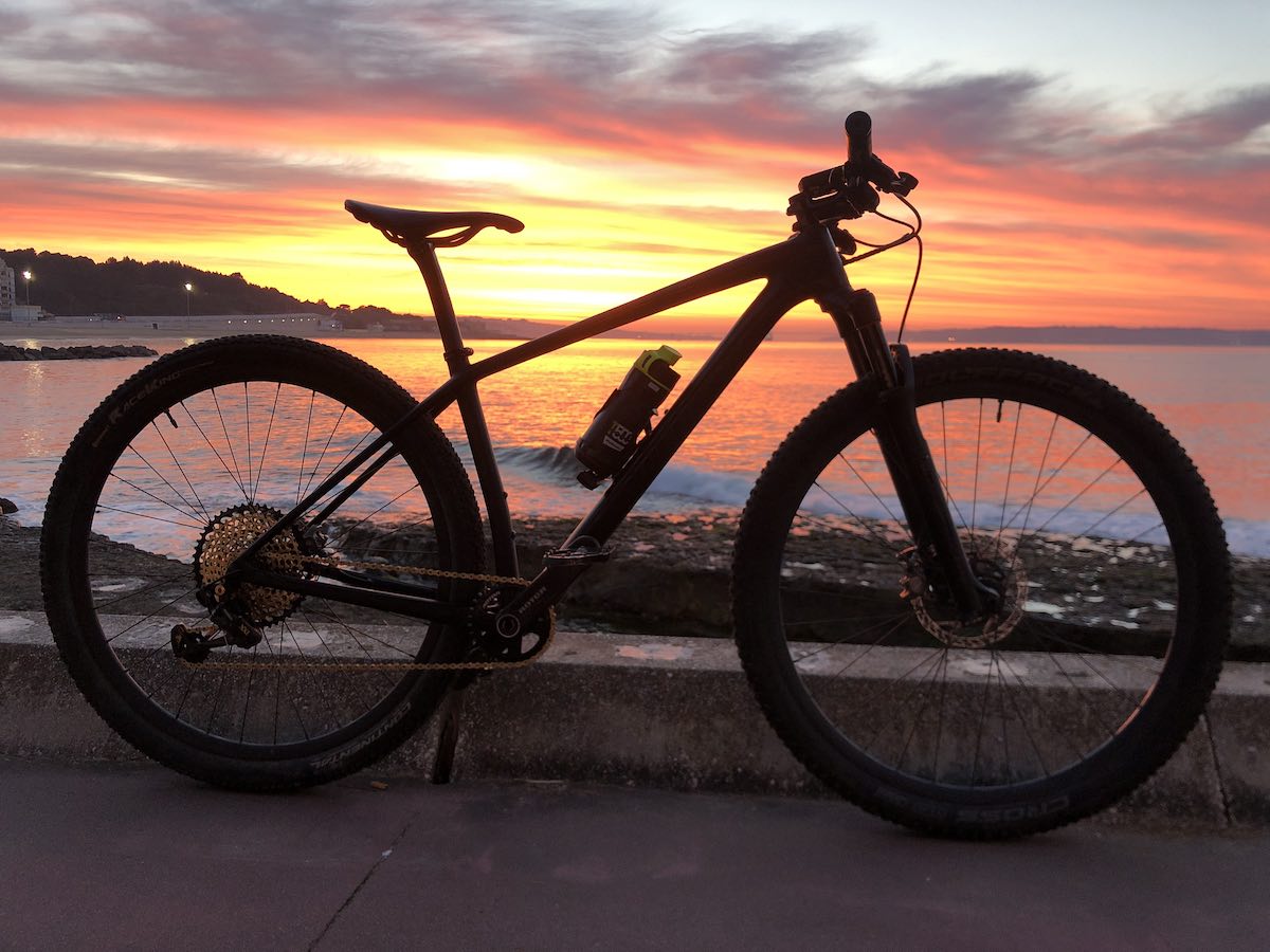 bikerumor pic of the day a silhouette of a bicycle with the orange and yellow sunrise behind on the beach.