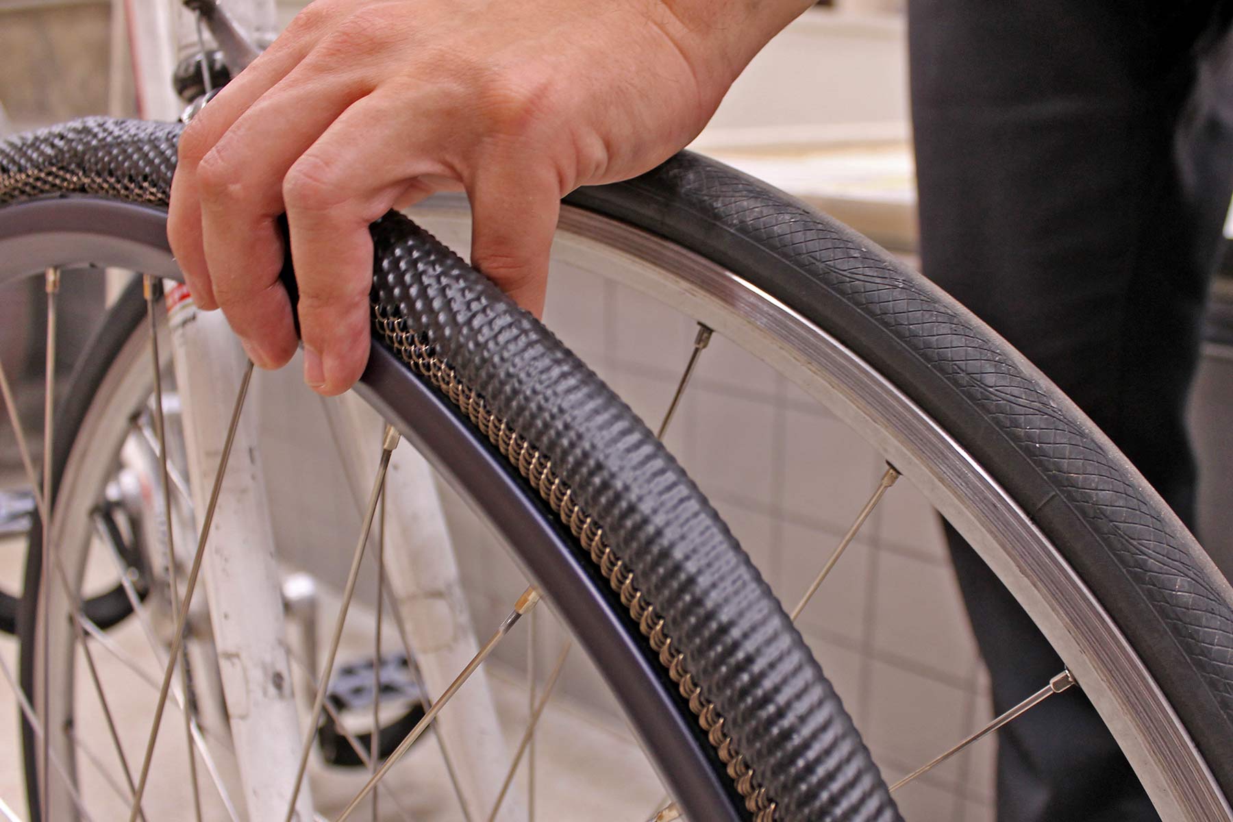 SMART METL airless no-flat bicycle tire prototype with rubber tread, old vs. new