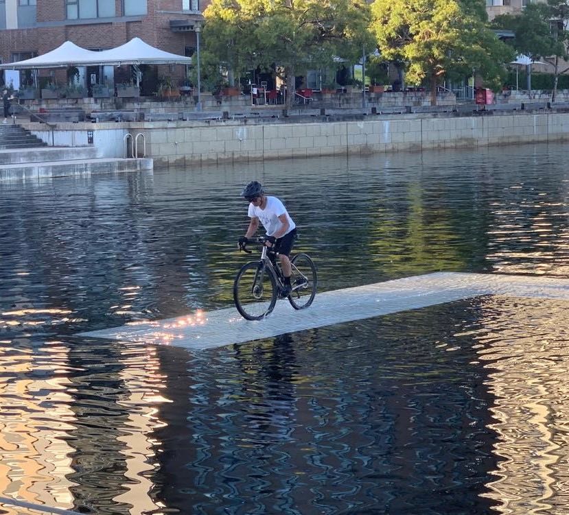 bikerumor pic of the day a gravel cyclist is on a small bridge that is under water in a by this makes the cyclist look like they're cycling on water.