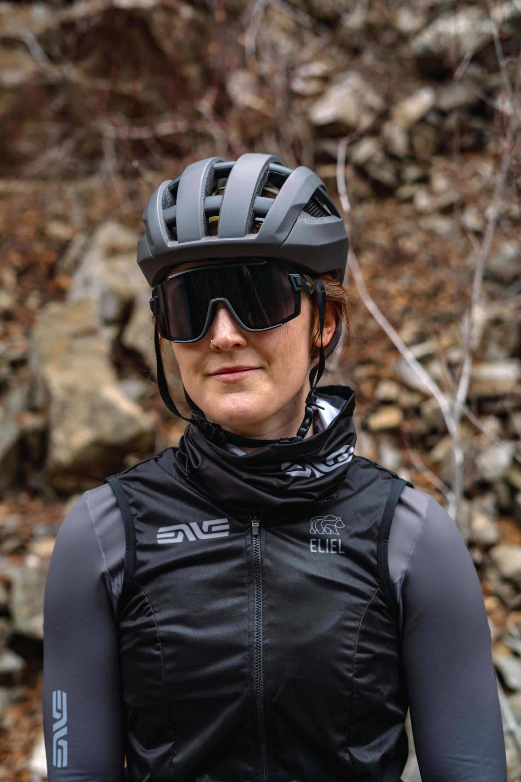 A woman wearing the ENVE neck gaiter and vest.