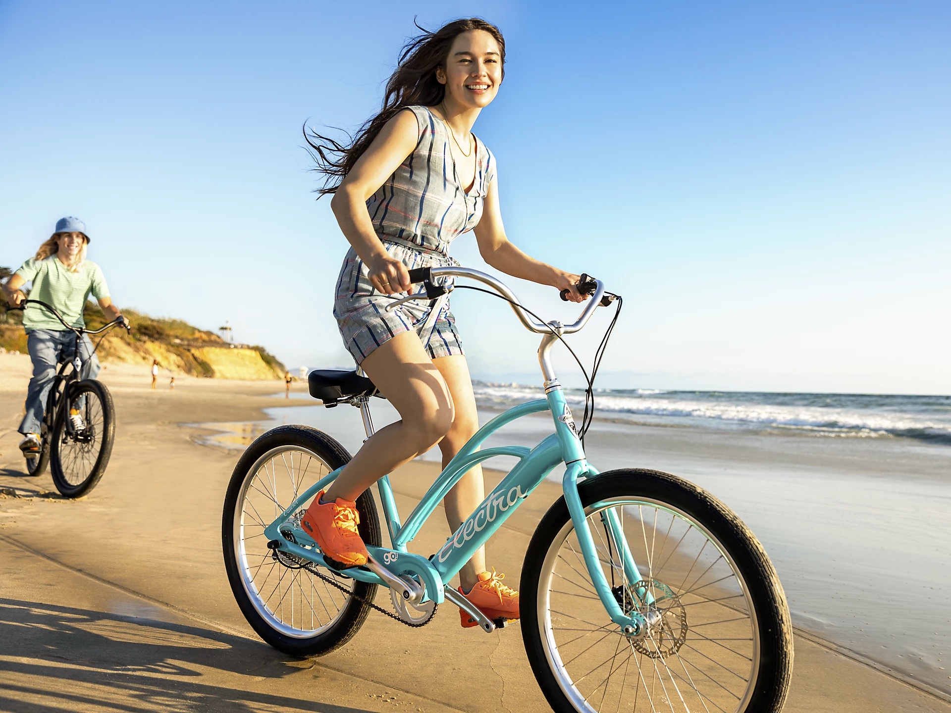 Electra Cruiser Go! Step Through bike being ridden on a beach.
