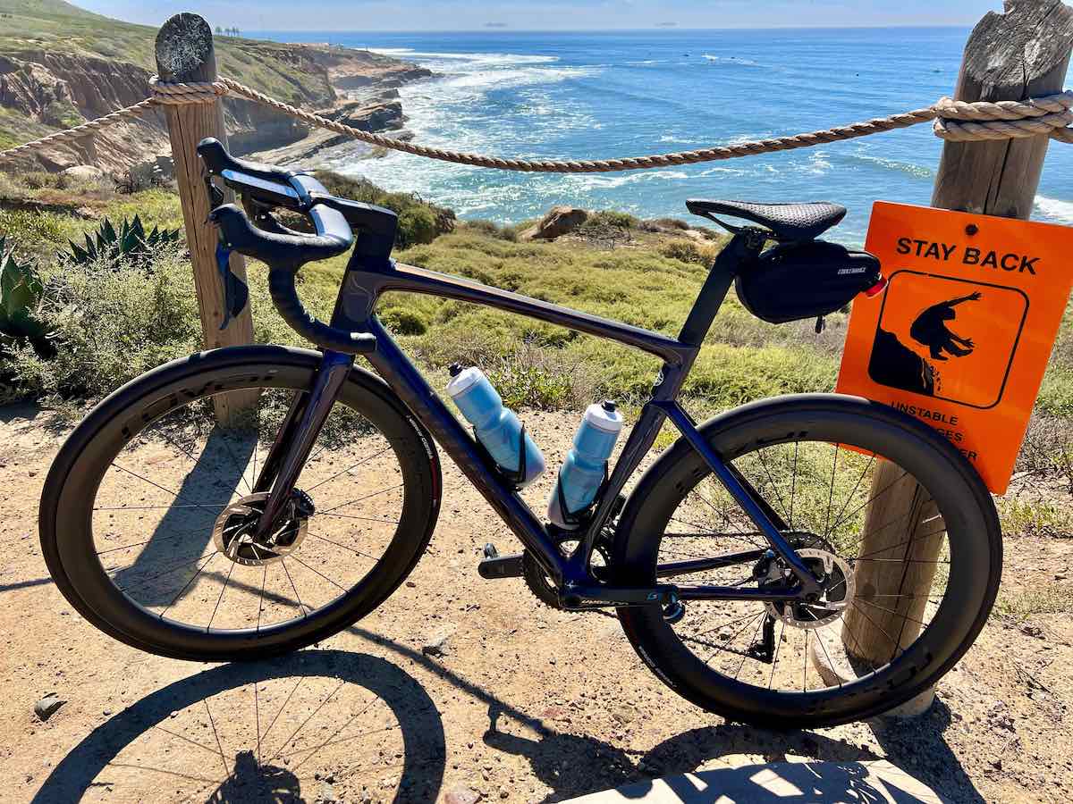 bikerumor pic of the day a bicycle is leaning against a wood and rope fence barrier at the top of a rocky outcropping over a tide pool near san diego california