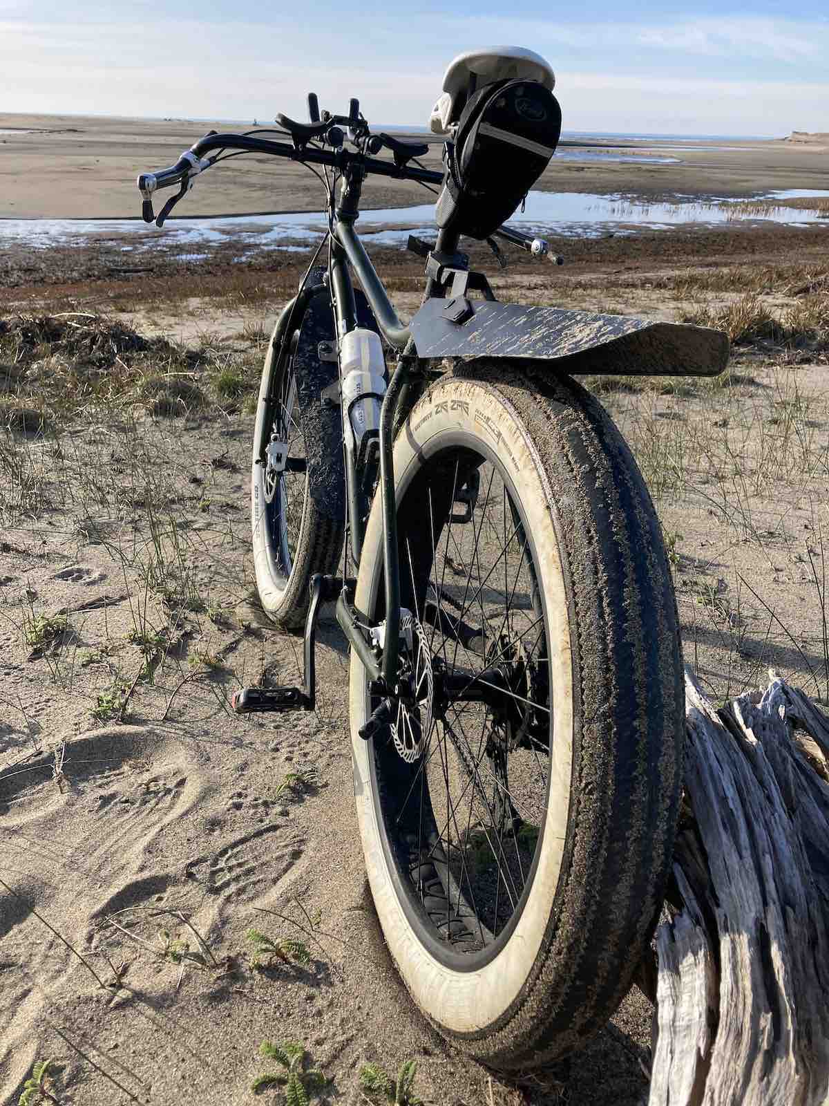 bikerumor pic of the day a fat bike in the mud on the edge of a river as it meets the sea.