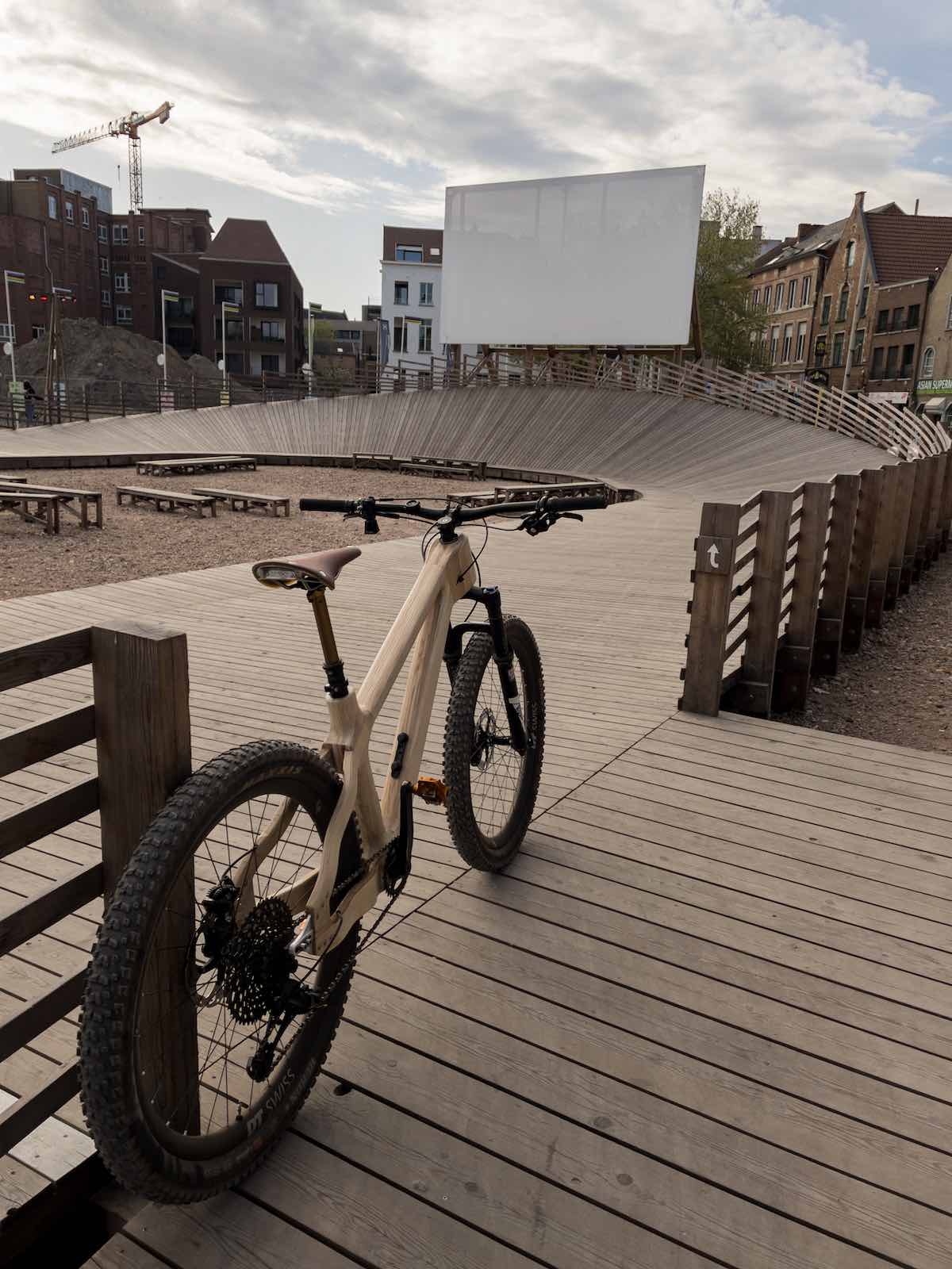 bikerumor pi of the day a bicycle made out of ash wood is positioned at the entrance to a wooden velodrome in leuven belgium.