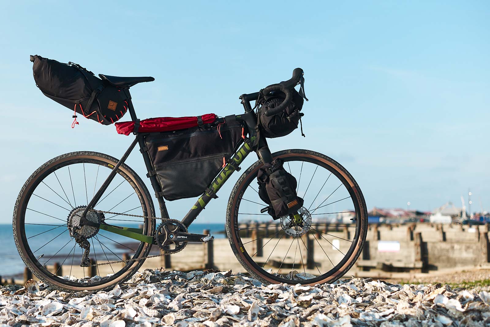 restrap full frame bag modfeled on gravel bike on beach