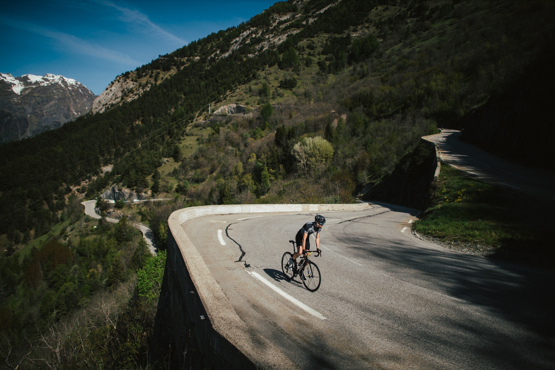 A rider climbs a road in a mountainous area.