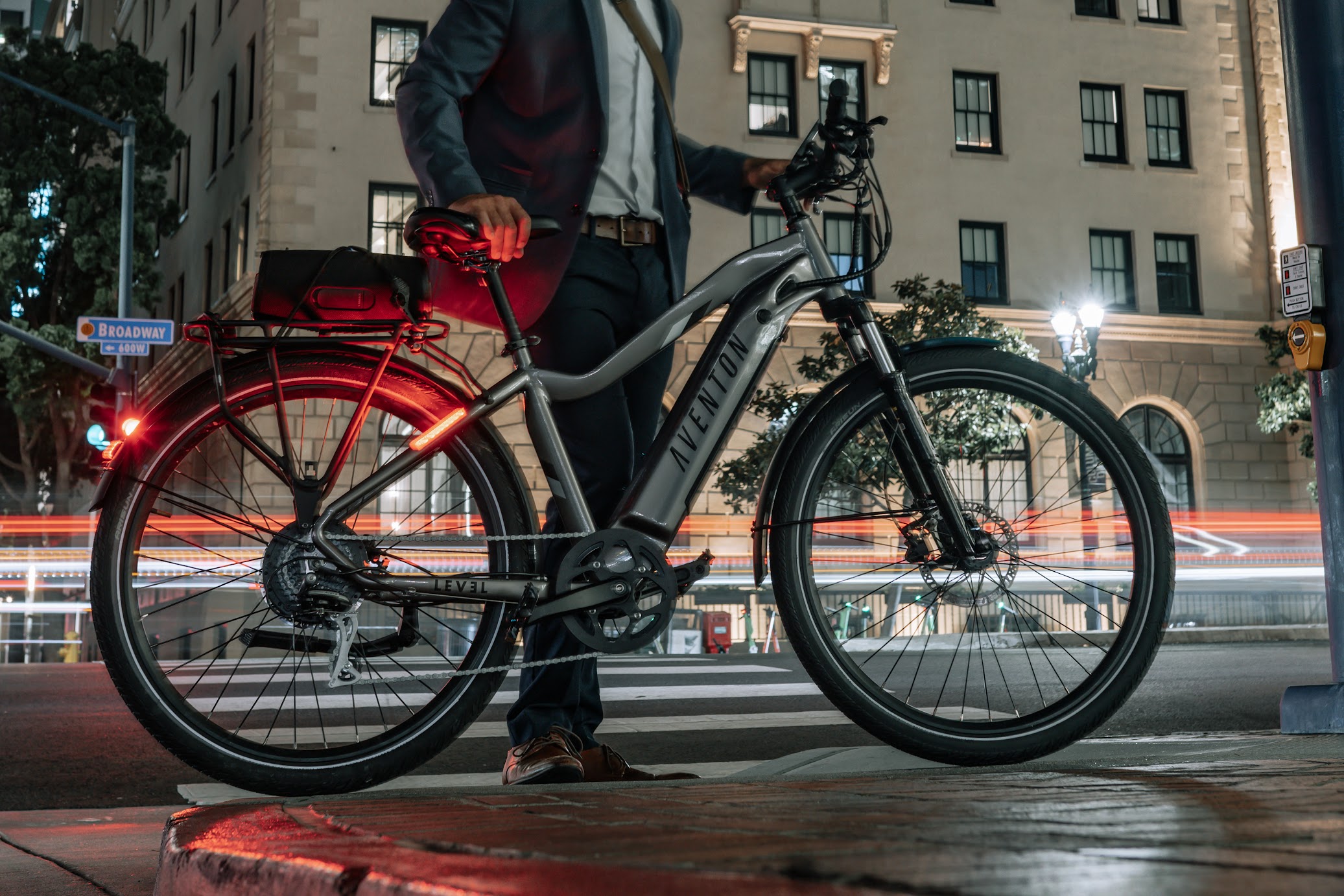 Aventon Level 2 bicycle with integrated taillights shining at night.