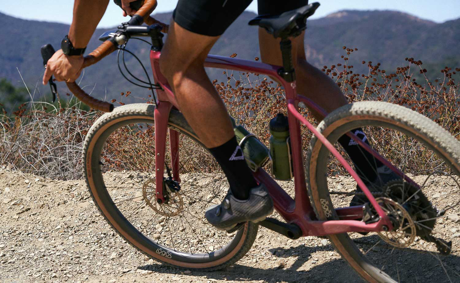 logos omnium atara carbon gravel wheels shown on a bike riding
