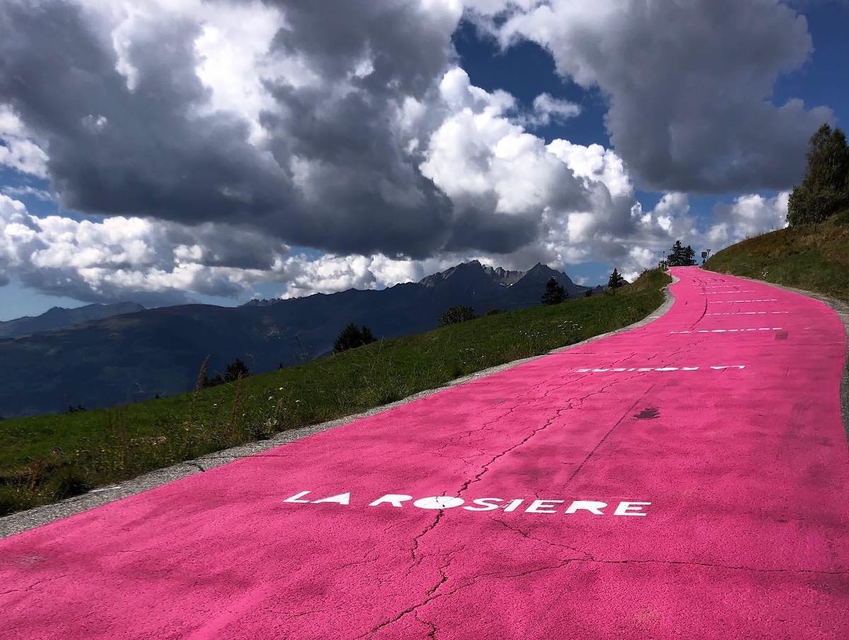Bikerumor pic of the day a road painted pink for the tour de france 2018 ascends up a mountain toward the cloudy sky in la rosiere france.