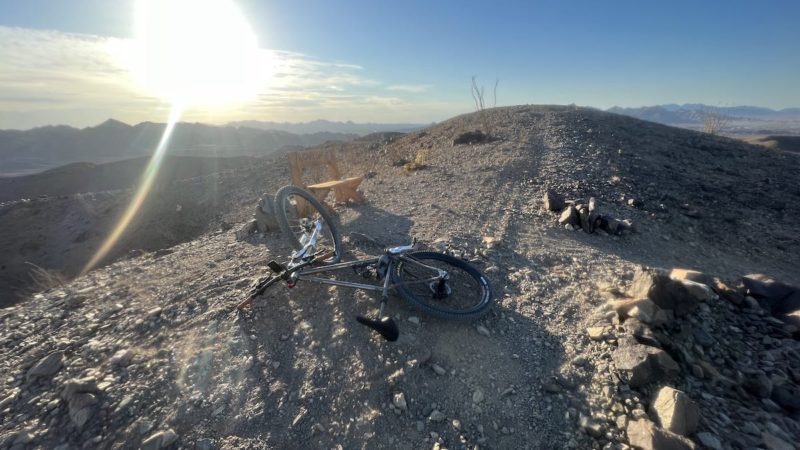 bikerumor pic of the day a mountain bike on top of a rocky peak looking out over the top as the sun sets below