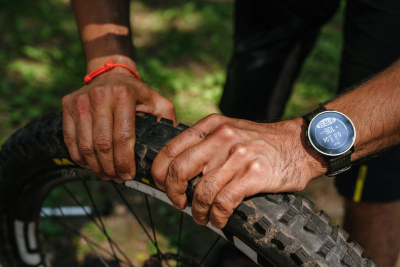 suunto 9 peak pro outdoor smartwatch shown on mountain biker