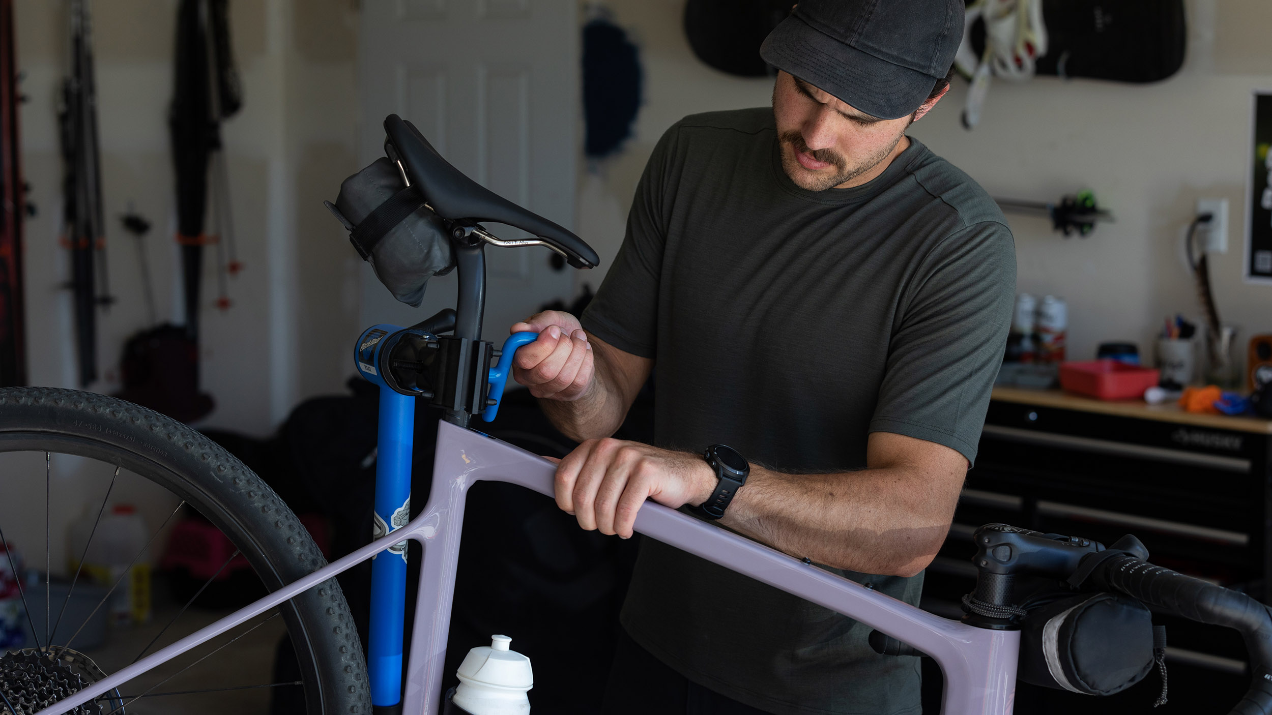 a man fixes a bike while wearing the ENVE merino tee