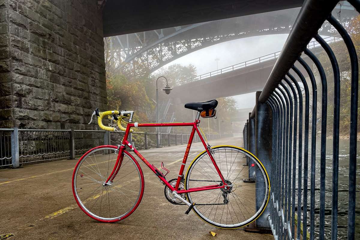 bikerumor pic of the day a fuji road bike is posed on a path under a bridge and it looks like there is fog and light rain
