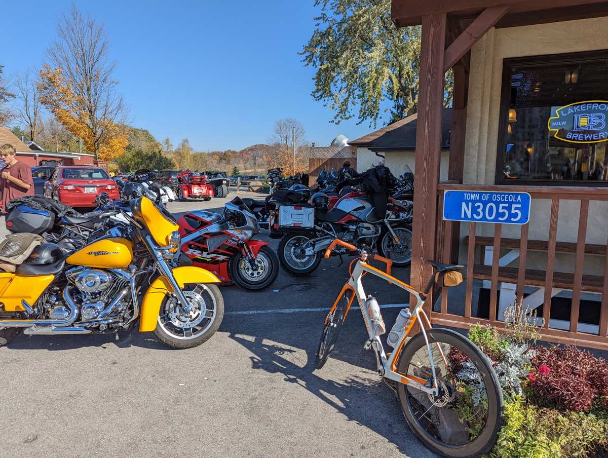 bikerumor pic of the day a bicycle, motorcycles and cars are parked outside of a country store on a beautiful fall day