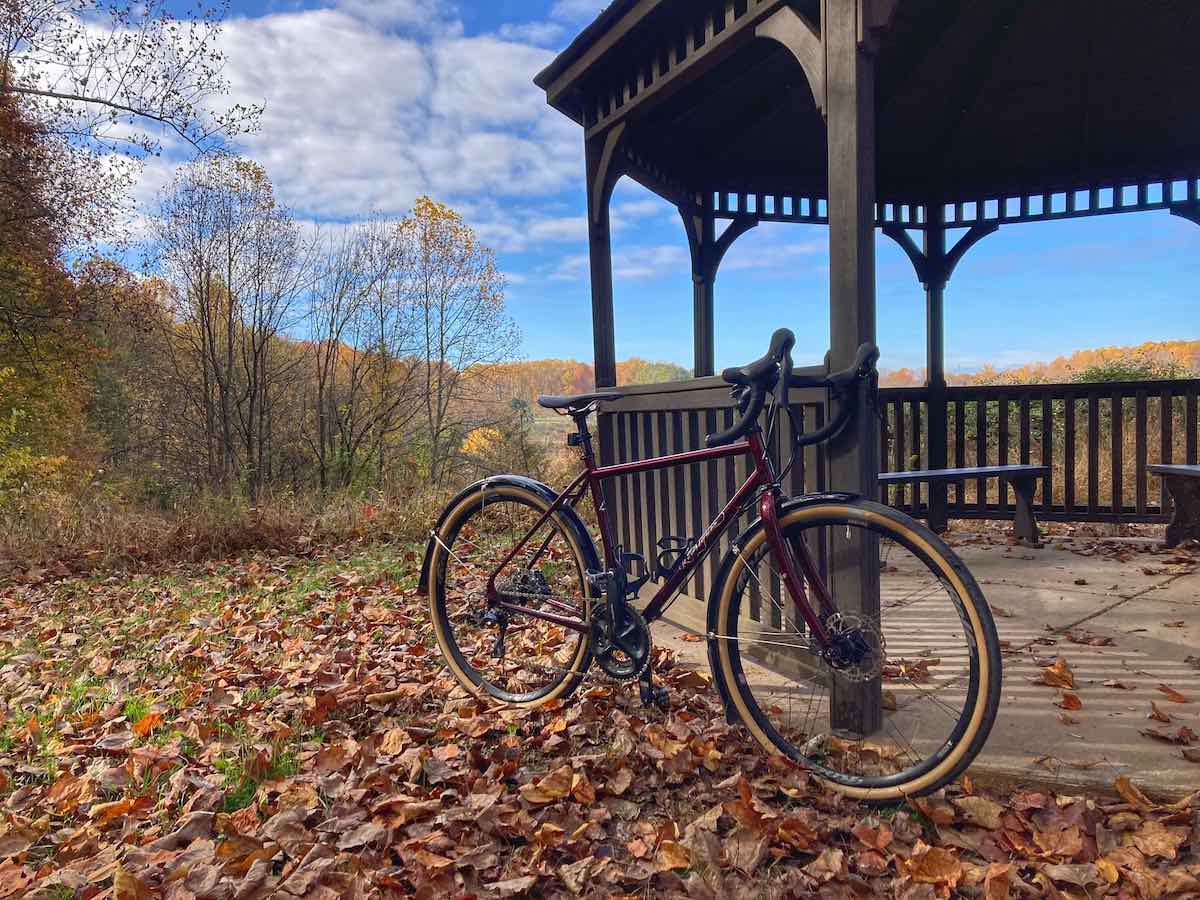 bikerumor pic of the day a bicycle leans against a wooden structure along a trail covered in fallen leaves