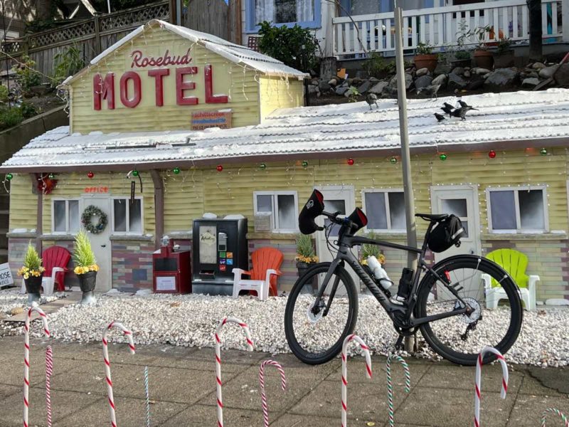 bikerumor pic of the day a bicycle leans against a pole in front of a miniature rosebud motel decorated for the holidays