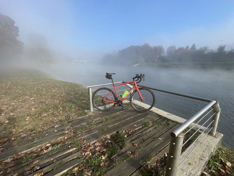 bikerumor pic of the day a bicycle leans on a railing of a boardwalk overlooking a fog covered river
