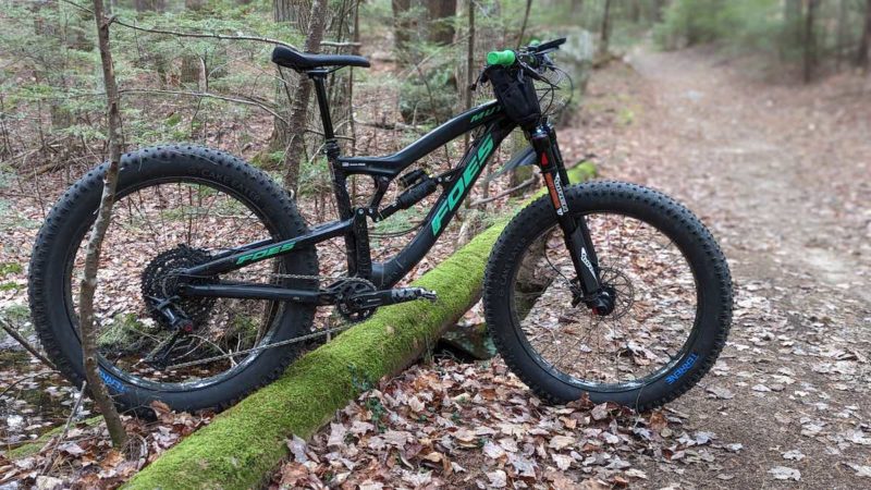 bikerumor pic of the day a mountain bike is posed on a fallen log along a dirt trail