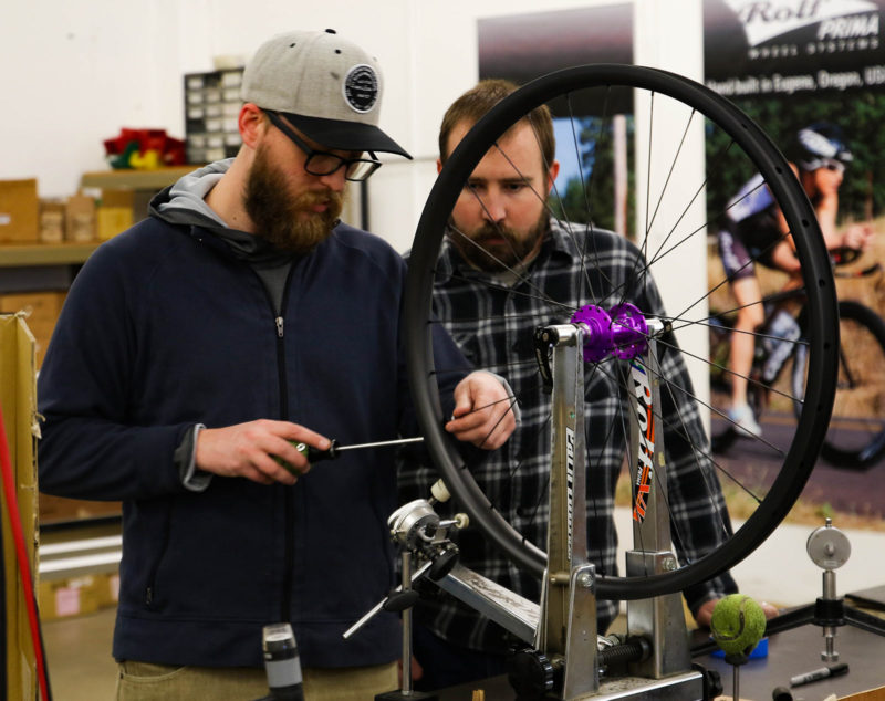 Alec White learning how to build a bike wheel
