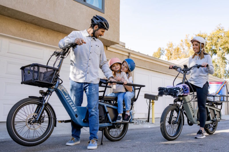 a family with children on aventon abound bikes
