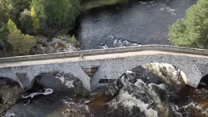 Crossing a stone bridge deep in Scotland's Cairngorms National Park.