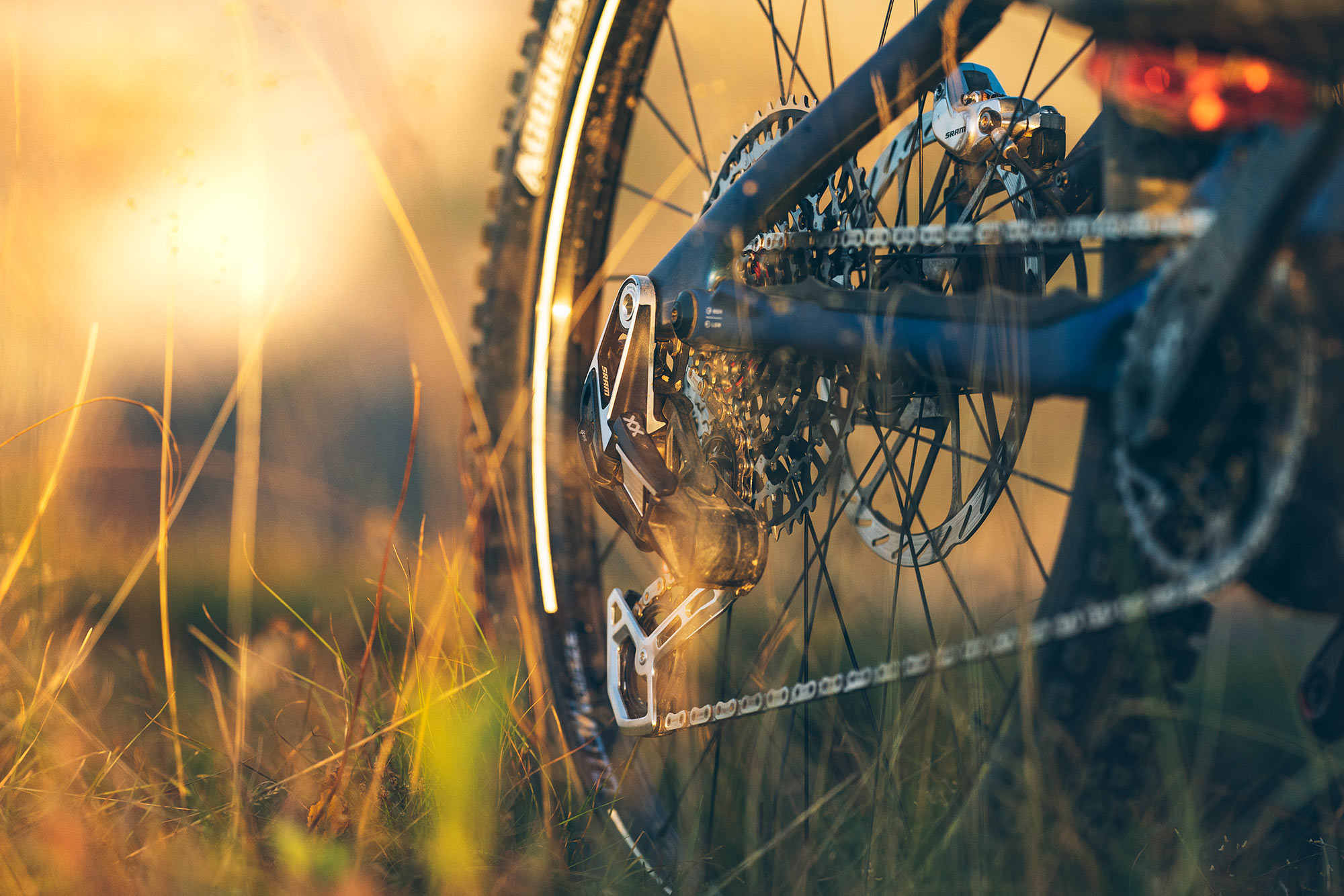 2023 SRAM Transmission mountain bike drivetrain shown on a bike in a field