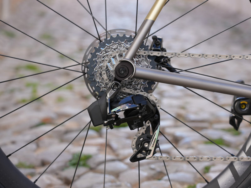 2023 sram force axs road bike group closeup details of rear derailleur & cassette