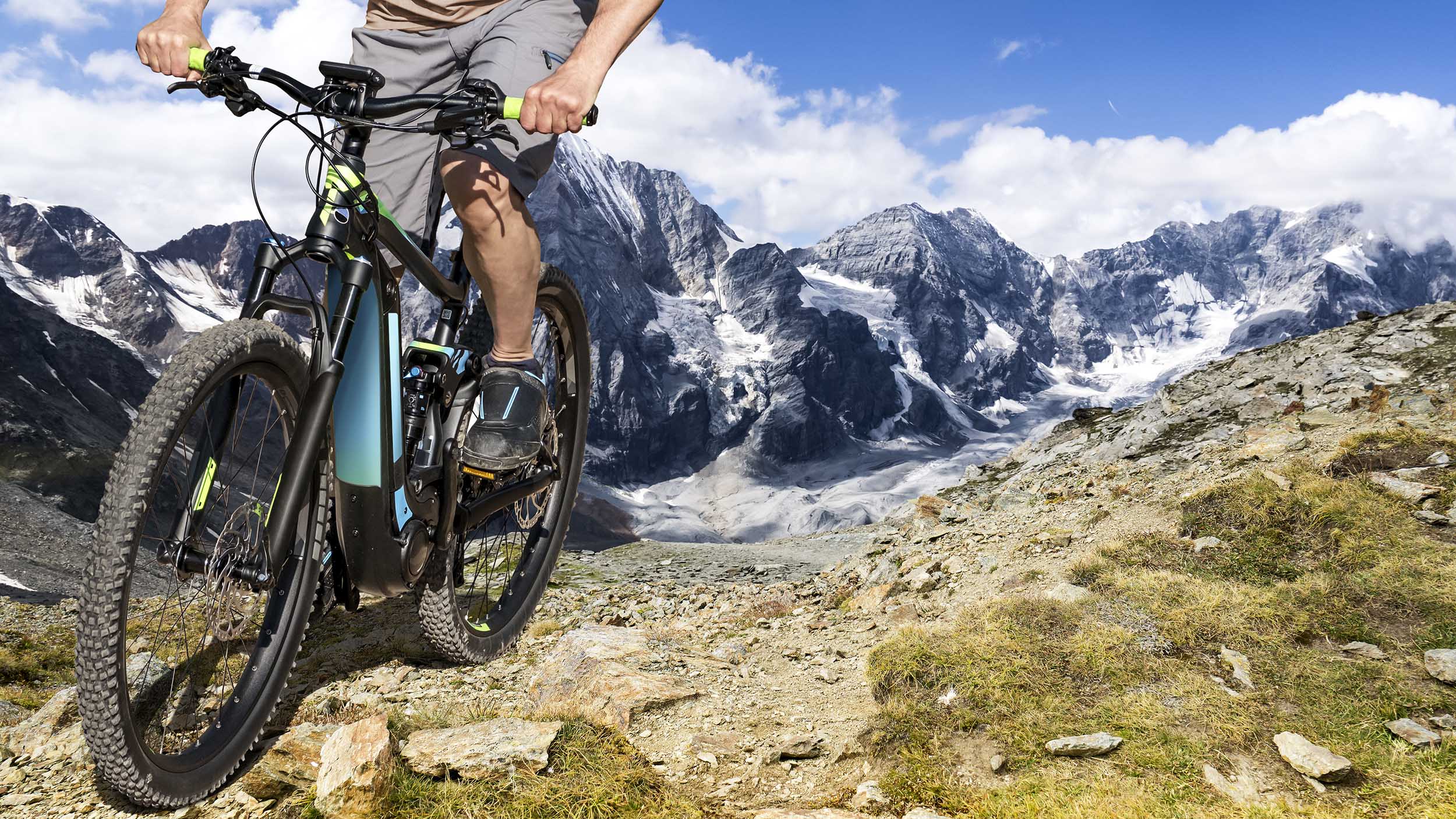 a man rides an eBike along a mountain trail