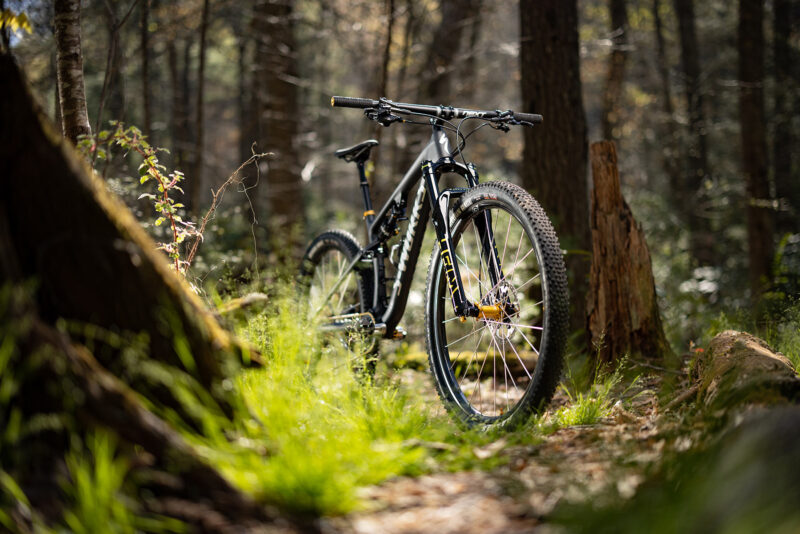 2023 cane creek works series helm 130mm trail fork shown on a mountain bike in the woods