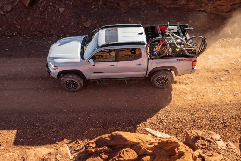 truck with a rear rack, bike, and camping equipment