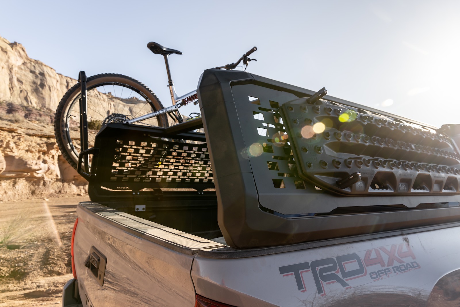 truck bed rack with molle panels and a montain bike