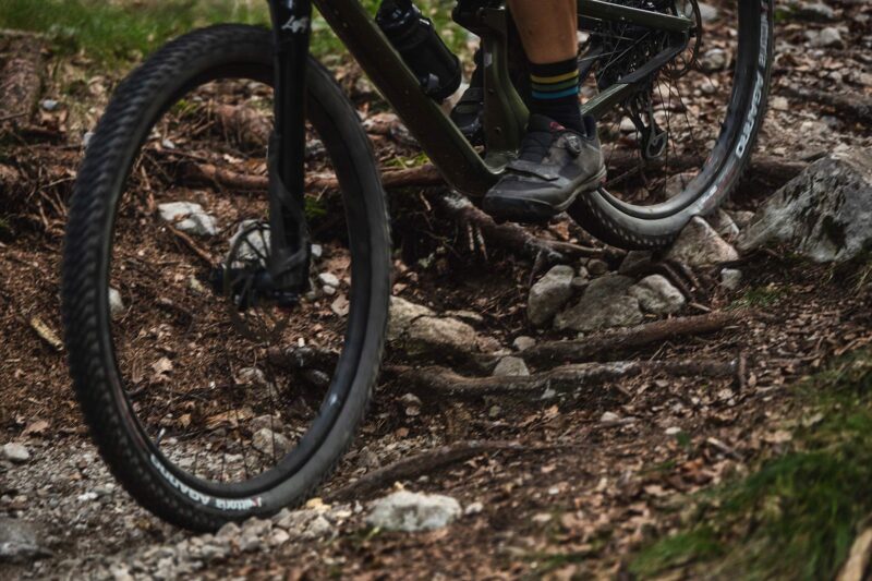 closeup of wheels on mountain biker riding with vittoria air-liner light tire inserts
