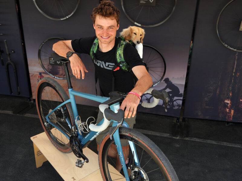 Alexey Vermeulen with his custom painted ENVE mod gravel bike and willie the weiner dog cyclist