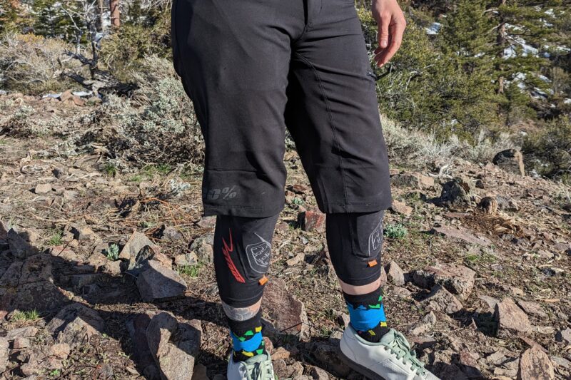 100% Ridecamp women's mountain bike shorts worn with knee pads