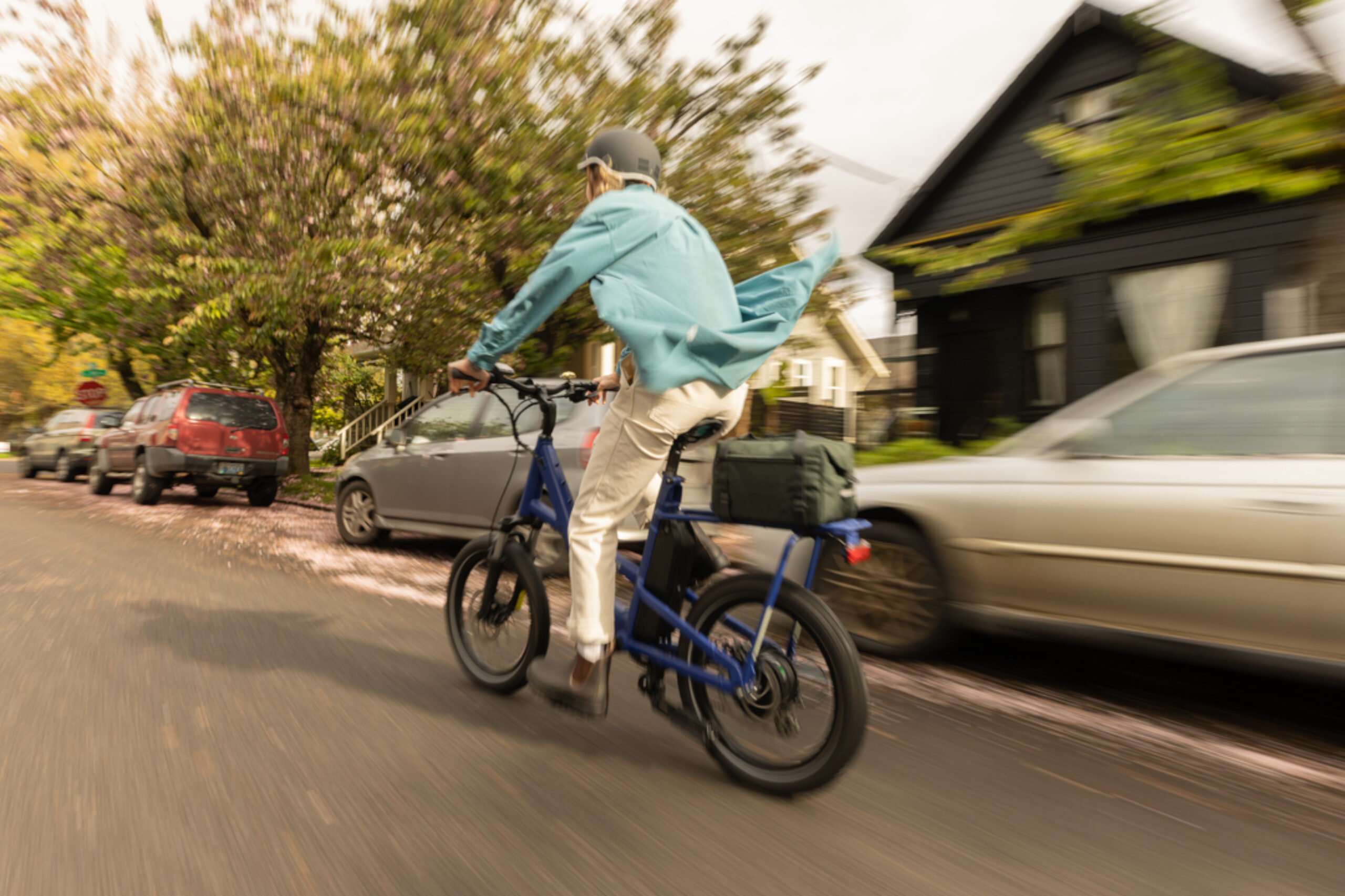 A man riding a bicycle in a neighborhood.