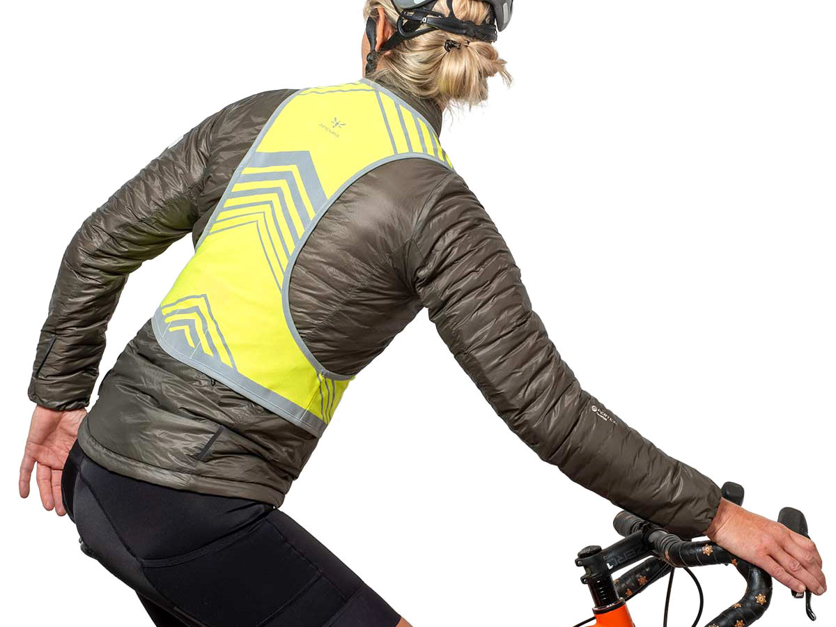 Apidura Packable Visibility Vest, lightweight road cycling-fitted EN Certified hi-viz vest, over a puffy jacket